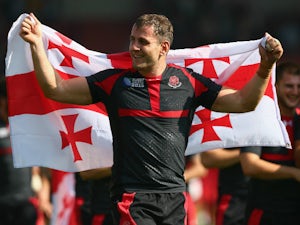 Giorgi Nemsadze of Georgia celebrates with his national flag after his team won the 2015 Rugby World Cup Pool C match between Tonga and Georgia at Kingsholm Stadium on September 19, 2015 in Gloucester, United Kingdom.