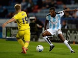 Mustapha Carayol of Huddersfield Town looks to get past Jamie Ward of Nottingham Forest during the Sky Bet Championship match between Huddersfield Town and Nottingham Forest at John Smiths Stadium on September 24, 2015