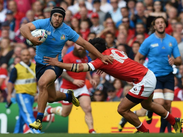 Italy's scrum half Edoardo Gori (L) evades a tackle by Canada's fly half Nathan Hirayama during a Pool D match of the 2015 Rugby World Cup between Italy and Canada at Elland Road in Leeds, north England, on September 26, 2015.