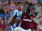 Jordan Brown of West Ham United battles with Joe Edwards of Colchester United during the pre season friendly match between Colchester and West Ham United at Weston Homes Community Stadium on July 21, 2015