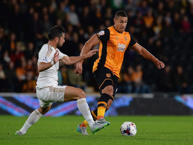 Jordi Amat of Swansea City tackles Jake Livermore of Hull City during the Capital One Cup third round match between Hull City and Swansea City at KC Stadium on September 22, 2015 in Hull, England.