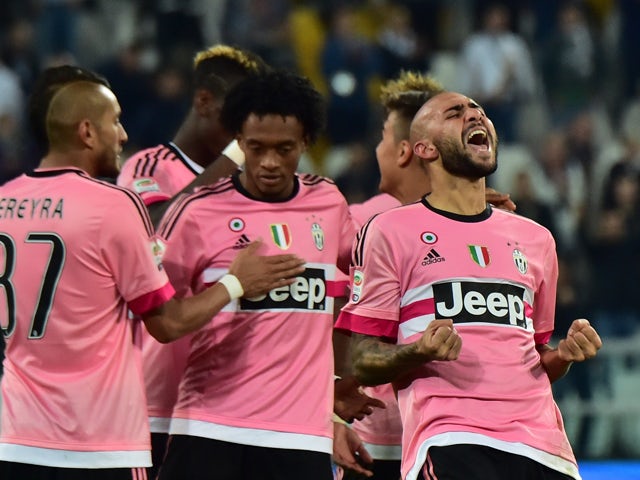 Juventus' forward from Italy Simone Zaza (R) celebrates after scoring a goal during the Serie A football match Juventus vs Frosinione at 'Juventus Stadium' in Turin on September 23, 2015