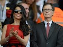 Liverpool's US owner John W. Henry (R) and his wife Linda Pizzuti are pictured before the start of the English Premier League football match between Liverpool and Bournemouth at the Anfield stadium in Liverpool, north-west England on August 17, 2015