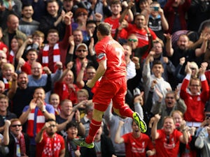 Liverpool's English midfielder James Milner celebrates after scoring his team's first goal during the English Premier League football match between Liverpool and Aston Villa at the Anfield stadium in Liverpool, north-west England, on September 26, 2015. 