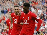 Liverpool's English striker Daniel Sturridge (R) celebrates after scoring his team's third goal during the English Premier League football match between Liverpool and Aston Villa at the Anfield stadium in Liverpool, north-west England on September 26, 201