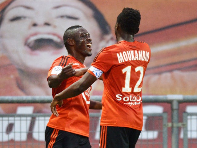 Lorient's Cameroonian forward Waris Majeed celebrates with his teammate Lorient's Cameroonian forward Benjamin Moukandjo after scoring a goal during the French L1 football match between Lorient and Caen on September 23, 2015