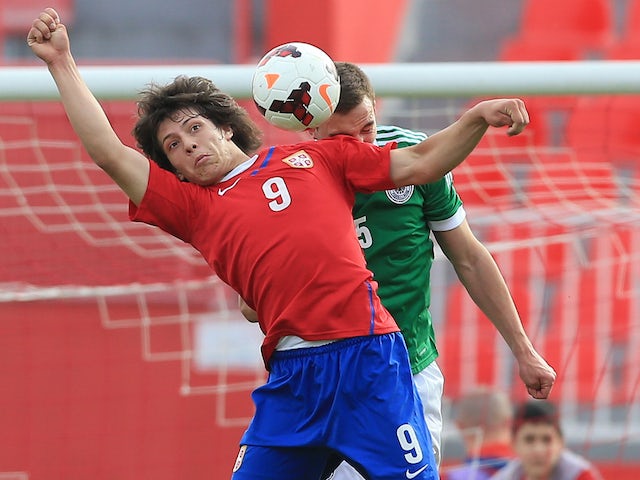 Luka Jovic (L) of Serbia jumps for the ball against Benedikt Gimber (R) of Germany during the UEFA Under17 Elite Round between Serbia and Germany at Stadion Karadjordje on March 31, 2014 in Novi Sad, Serbia.
