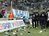In this picture taken on September 20, 2015 riot police patrol around the touchline after crowd trouble during the French L1 football match Marseille (OM) vs Lyon (OL) at the Velodrome Stadium in Marseille, southern France. Play was resumed after an inter