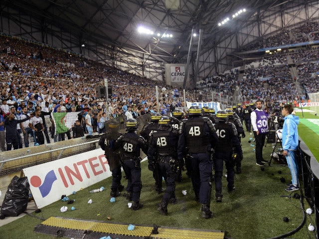 Riot police are pictured during a game interruption after crowd trouble during the French L1 football match Marseille (OM) vs Lyon (OL) on September 20, 2015 at Velodrome Stadium in Marseille, southern France. The match restarted after a 20-minute delay.