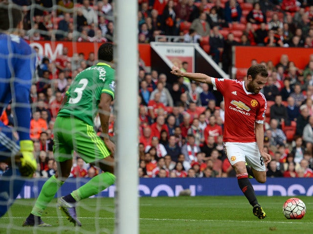 Manchester United's Spanish midfielder Juan Mata (R) shoots the score their third goal past Sunderland's Romanian goalkeeper Costel Pantilimon (L) during the English Premier League football match between Manchester United and Sunderland at Old Trafford in