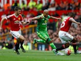 Younes Kaboul (C) of Sunderland competes against Michael Carrick (L) and Antonio Valencia (R) of Manchester United during the Barclays Premier League match between Manchester United and Sunderland at Old Trafford on September 26, 2015 in Manchester, Unite