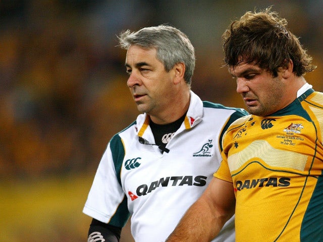 Doctor Martin Raftery helps Adam Freier of the Wallabies from the field during the 2007 Tri Nations match between the Australian Wallabies and the South African Springboks at Telstra Stadium on July 7, 2007 in Sydney, Australia.