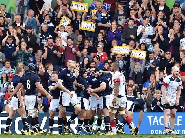 Scotland players celebrate with centre Matt Scott after scoring the third try of the match against USA in Rugby World Cup Pool B on September 27, 2015