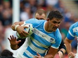 Pablo Matera of Argentina is tackled by Dan Carter of the New Zealand All Blacks during the 2015 Rugby World Cup Pool C match between New Zealand and Argentina at Wembley Stadium on September 20, 2015 