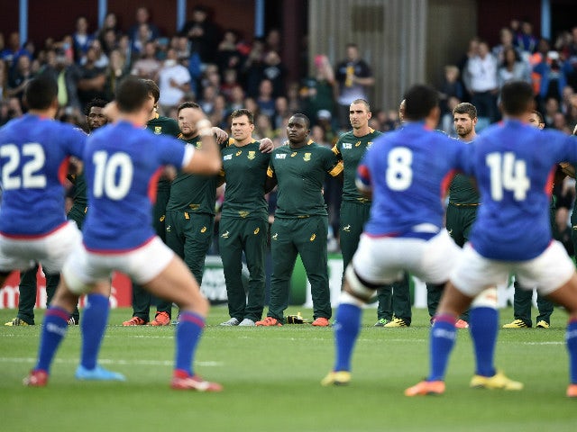 South Africa's prop Trevor Nyakane (C) stands with South Africa team mates as they watch the Samoa team perform the Haka ahead of the Pool B match of the 2015 Rugby World Cup between South Africa and Samoa at Villa Park in Birmingham, central England, on 