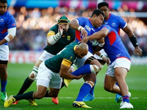 Ofisa Treviranus of Samoa is tackled by JP Pietersen of South Africa during the 2015 Rugby World Cup Pool B match between South Africa and Samoa at Villa Park on September 26, 2015 in Birmingham, United Kingdom.