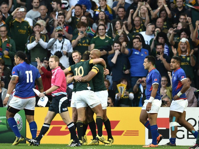 South Africa's wing JP Pietersen (C) celebrates with South Africa's fly half Handre Pollard after scoring his second try during the Pool B match of the 2015 Rugby World Cup between South Africa and Samoa at Villa Park in Birmingham, central England, on Se
