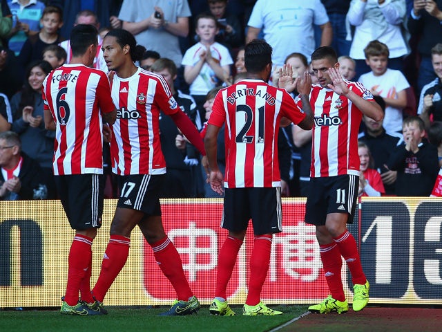Dusan Tadic (R) of Southampton celebrates scoring his team's second goal with his team mates during the Barclays Premier League match between Southampton and Swansea City at St Mary's Stadium on September 26, 2015