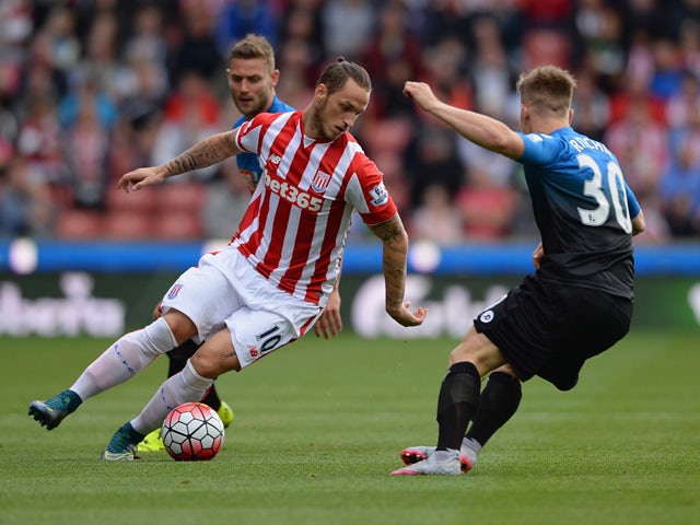 Marko Arnautovic of Stoke City and Matt Ritchie of Bournemouth compete for the ball during the Barclays Premier League match between Stoke City and A.F.C. Bournemouth at Britannia Stadium on September 26, 2015
