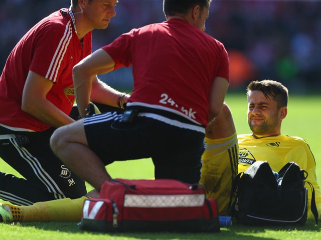 Lukasz Fabianski of Swansea City receives a medical treatment during the Barclays Premier League match between Southampton and Swansea City at St Mary's Stadium on September 26, 2015