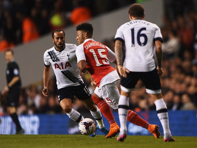 Alex Oxlade-Chamberlain of Arsenal is watched by Andros Townsend (L) and Kieran Trippier of Tottenham Hotspur (R) during the Capital One Cup third round match between Tottenham Hotspur and Arsenal at White Hart Lane on September 23, 2015 