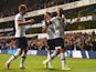 Nacer Chadli of Tottenham Hotspur (R) celebrates with Tommy Carroll (C) and Harry Kane (L) as Calum Chambers of Arsenal scores an own goal foe their first goal during the Capital One Cup third round match between Tottenham Hotspur and Arsenal at White Har