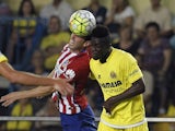 Atletico Madrid's Uruguayan defender Diego Godin (L) vies with Villarreal's Ivorian defender Eric Bally during the Spanish league football match Villarreal CF vs Club Atletico de Madrid at El Madrigal stadium in Villareal on September 26, 2015.