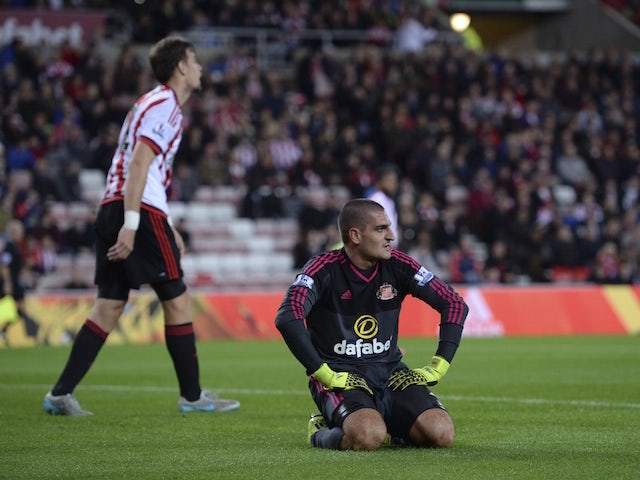 Sunderland's Italian goalkeeper Vito Mannone (R) reacts after Manchester City's third goal which was an own goal credited to Mannone after the ball ricocheted off the post to go in off the goalkeeper during the English League Cup third round football matc