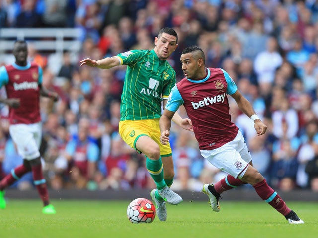 Dimitri Payet of West Ham United and Graham Dorrans of Norwich City compete for the ball during the Barclays Premier League match between West Ham United and Norwich City at the Boleyn Ground on September 26, 2015