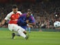 Arsenal's English midfielder Alex Oxlade-Chamberlain (L) shoots but hits the side netting and misses the chance under pressure from Olympiakos's Brazilian defender Leandro Salino (R) during the UEFA Champions League Group F football match between Arsenal 