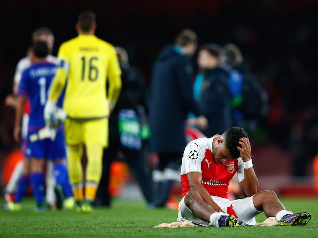Alex Oxlade-Chamberlain of Arsenal sits dejected after the UEFA Champions League Group F match between Arsenal FC and Olympiacos FC at the Emirates Stadium on September 29, 2015 in London, United Kingdom.