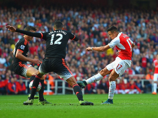 Alexis Sanchez of Arsenal scores arsenal's 3rd goal during the Barclays Premier League match between Arsenal and Manchester United at Emirates Stadium on October 4, 2015 in London, England.