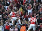 Arsenal's Chilean striker Alexis Sanchez (C) celebrates scoring his goal with team mates Arsenal's German midfielder Arsenal's English midfielder Theo Walcott (L) during the English Premier League football match between Arsenal and Manchester United at th