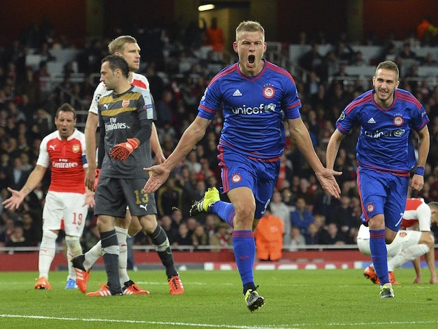 Olympiakos's Icelandic striker Alfred Finnbogason (C) celebrates scoring their third goal during the UEFA Champions League Group F football match between Arsenal and Olympiakos at The Emirates Stadium in north London on September 29, 2015. 