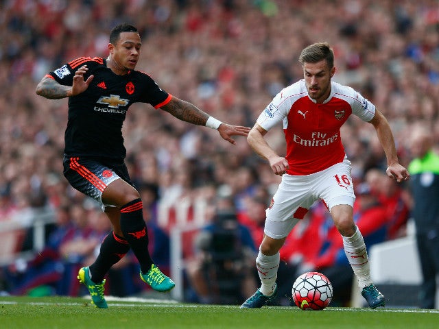 Memphis Depay of Manchester United and Aaron Ramsey of Arsenal during the Barclays Premier League match between Arsenal and Manchester United at Emirates Stadium on October 4, 2015 in London, England.