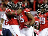 Jonathan Babineaux #95 celebrates with O'Brien Schofield #50 of the Atlanta Falcons after an interception in the first half against the Houston Texans at the Georgia Dome on October 4, 2015