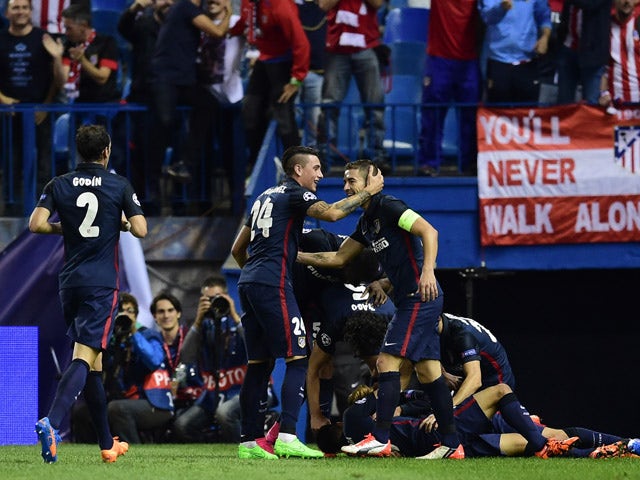 Atletico Madrid players celebrate after scoring a goal during the UEFA Champions League football match Club Atletico de Madrid vs SL Benfica at the Vicente Calderon stadium in Madrid on September 30, 2015