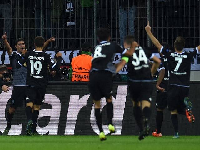 Monchengladbach's midfielder Lars Stindl celebrates scoring with his team-mates during the UEFA Champions League first-leg Group D football match between Borussia Monchengladbach and Manchester City in Monchengladbach, western Germany on September 30, 201