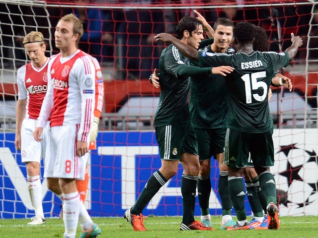Real Madrid's Portuguese forward Cristiano Ronaldo (2nd R) is congratuled by teammates after scoring a goal during the UEFA Champions League Group D football match Ajax Amsterdam vs Real Madrid on October 3, 2012