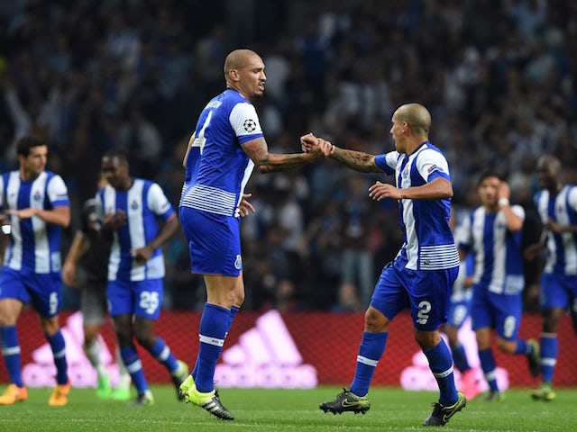 Porto's Brazilian defender Maicon (L) celebrates a goal with Porto's Uruguayan defender Maxi Pereira (R) during the UEFA Champions League Group G football match at the Dragao stadium in Porto on September 29, 2015.