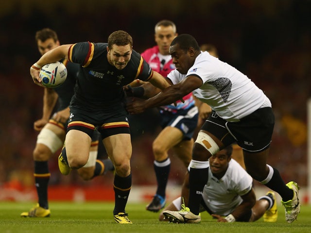 George North of Wales breaks through the challenge of Manasa Saulo of Fiji during the 2015 Rugby World Cup Pool A match between Wales and Fiji at Millennium Stadium on October 1, 2015