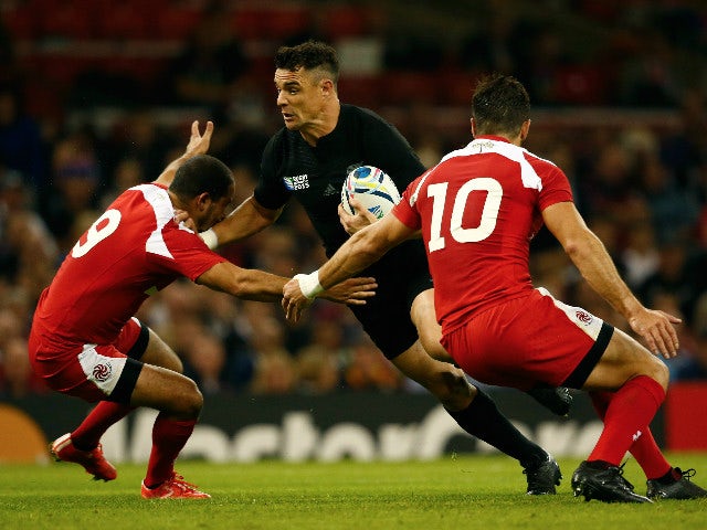 Dan Carter of the New Zealand All Blacks is stopped by Giorgi Begadze (L) and Lasha Malaguradze of Georgia during the 2015 Rugby World Cup Pool C match between New Zealand and Georgia at the Millennium Stadium on October 2, 2015 in Cardiff, United Kingdom
