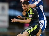James Husband of Middlesbrough is tackled by Danny Philliskirk of Oldham during the Capital One Cup First Round match between Oldham Athletic and Middlesbrough at Boundary Park on August 12, 2014 in Oldham, England.