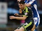 James Husband of Middlesbrough is tackled by Danny Philliskirk of Oldham during the Capital One Cup First Round match between Oldham Athletic and Middlesbrough at Boundary Park on August 12, 2014 in Oldham, England.