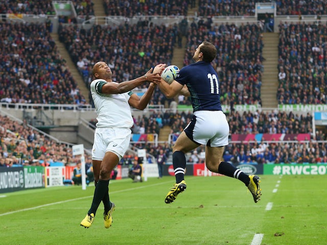 JP Pietersen of South Africa and Tim Visser of Scotland jump for the ball during the 2015 Rugby World Cup Pool B match between South Africa and Scotland at St James' Park on October 3, 2015 in Newcastle upon Tyne, United Kingdom.
