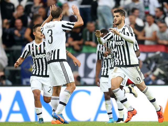 Juventus' forward Alvaro Morata from Spain (R) celebrates with teammate Juventus' defender from Italy Giorgio Chiellini after scoring during the Italian Serie A football match Juventus Vs Bologna on October 4, 2015