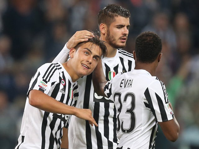 Juventus' forward Paulo Dybala from Argentina celebrates after scoring with his teammate Juventus' forward Alvaro Morata from Spain during the Italian Serie A football match Juventus Vs Bologna on October 4, 2015