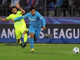 Gent's Israeli midfielder Kenny Saief (L) vies with Zenit's Brazilian forward Hulk during the UEFA Champions League group H football match between FC Zenit and KAA Gent at the Petrovsky stadium in St. Petersburg on September 29, 2015. 