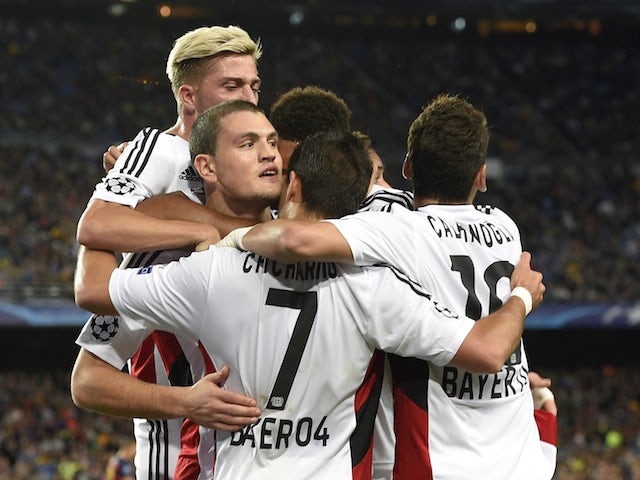 Bayer Leverkusen's Greek defender Kyriakos Papadopoulos (2nd L) celebrates a goal with his teammates during the UEFA Champions League Group E football match between FC Barcelona and Bayer Leverkusen.