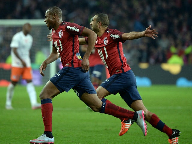 Lille's French defender Djibril Sidibe (L) celebrates with Lille's Moroccan midfielder Mounir Obbadi (R) during the French L1 football match between Lille and Montpellier on October 2, 2015 at the Pierre Mauroy stadium in Villeneuve d'Ascq, northern Franc
